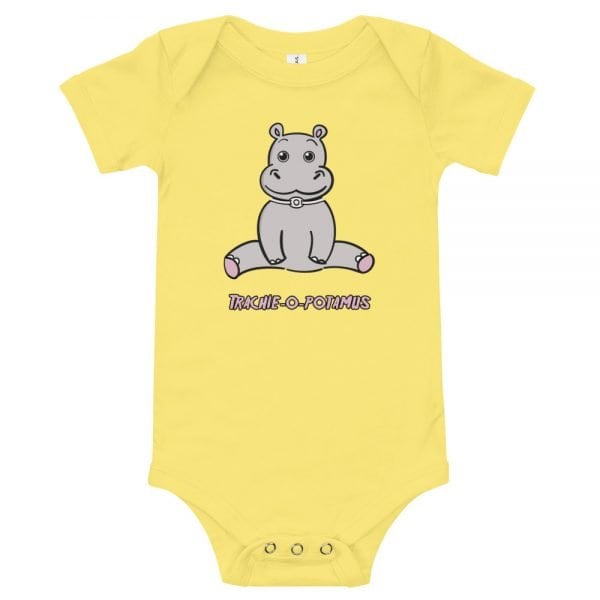 Tracheostomy Onsie in yellow with an image of a hippopotamus with a tracheostomy tube and words Trachieopotamus underneathe